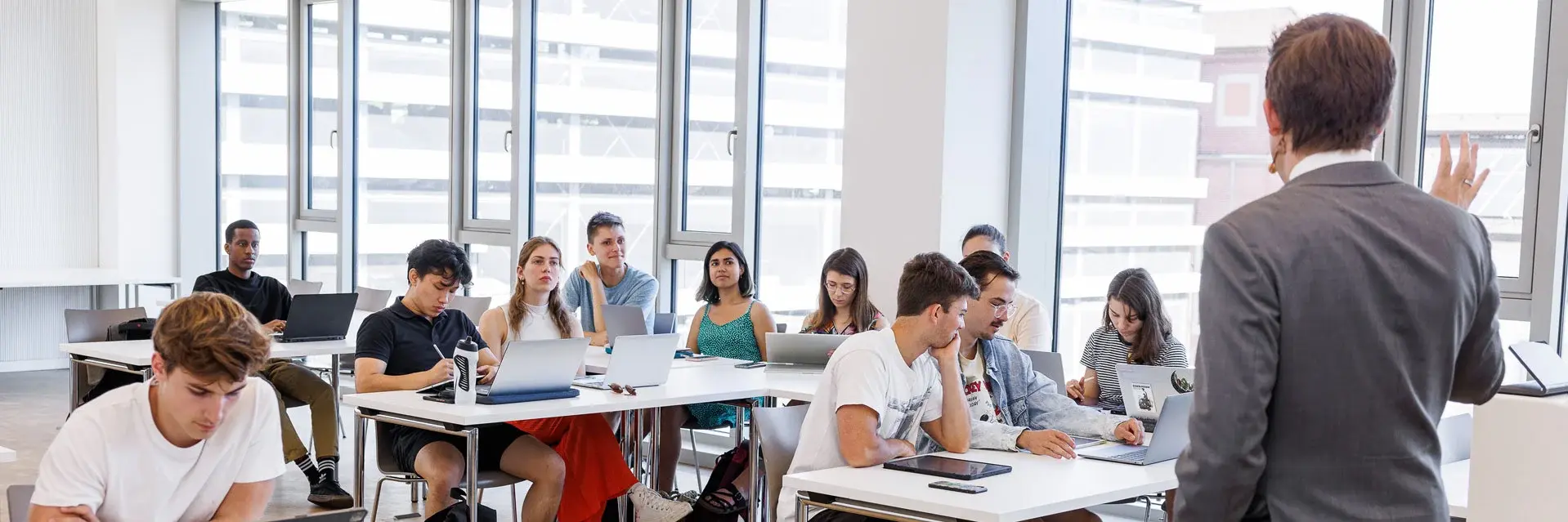 Professor lecturing to a full classroom of students