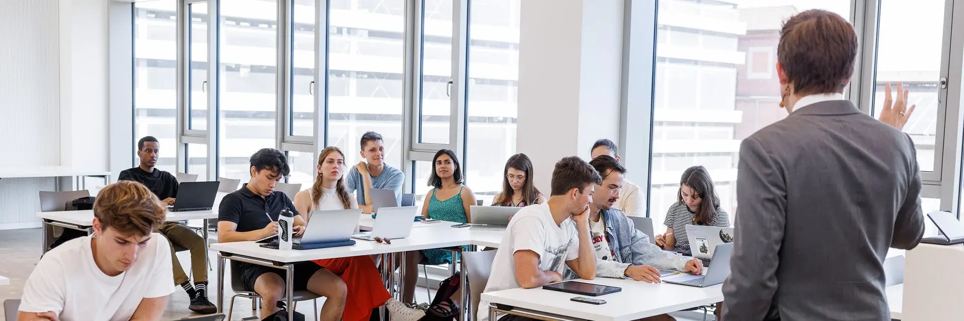 Professor lecturing to a full classroom of students