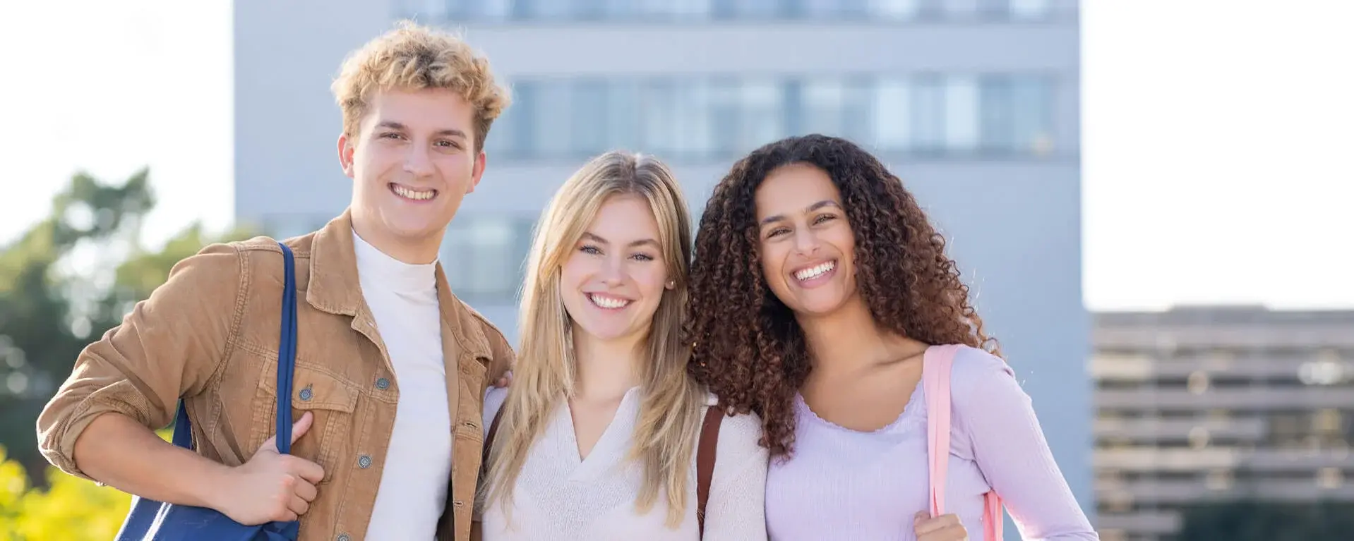 Three students posing on campus