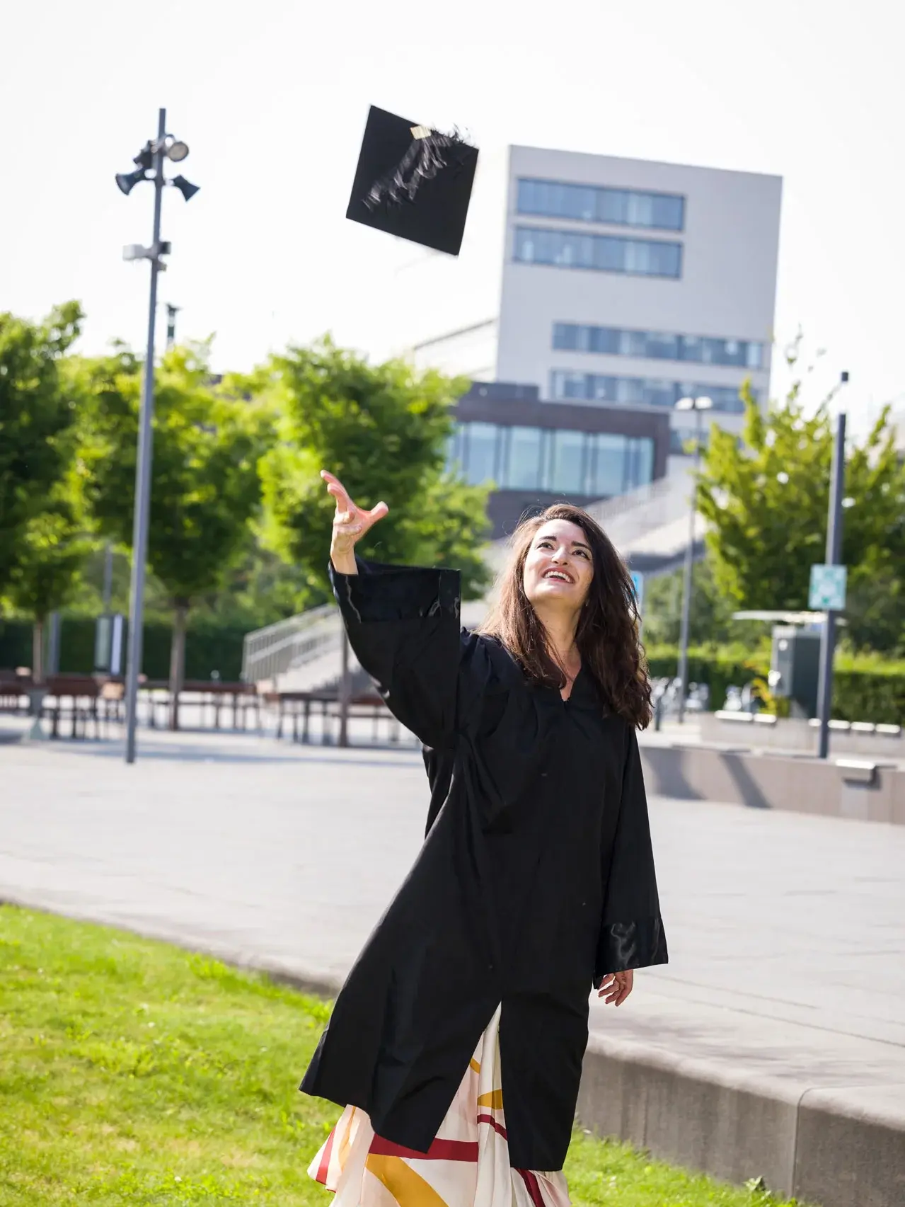 Alumni throwing graduation hat