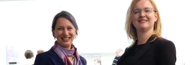 two formally dressed women standing