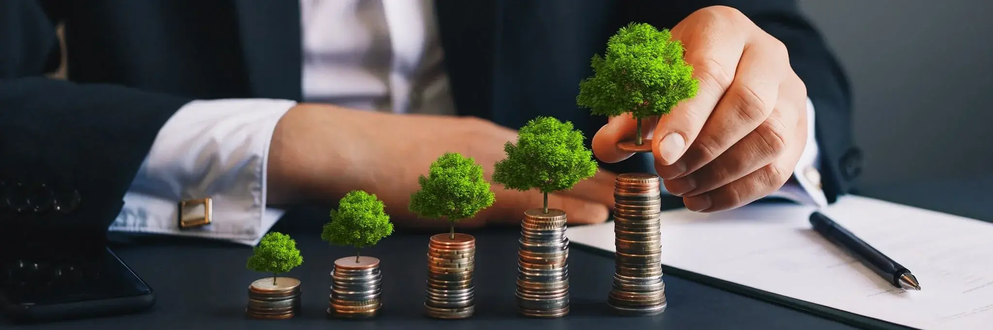 Stacked coins with plastic trees on them